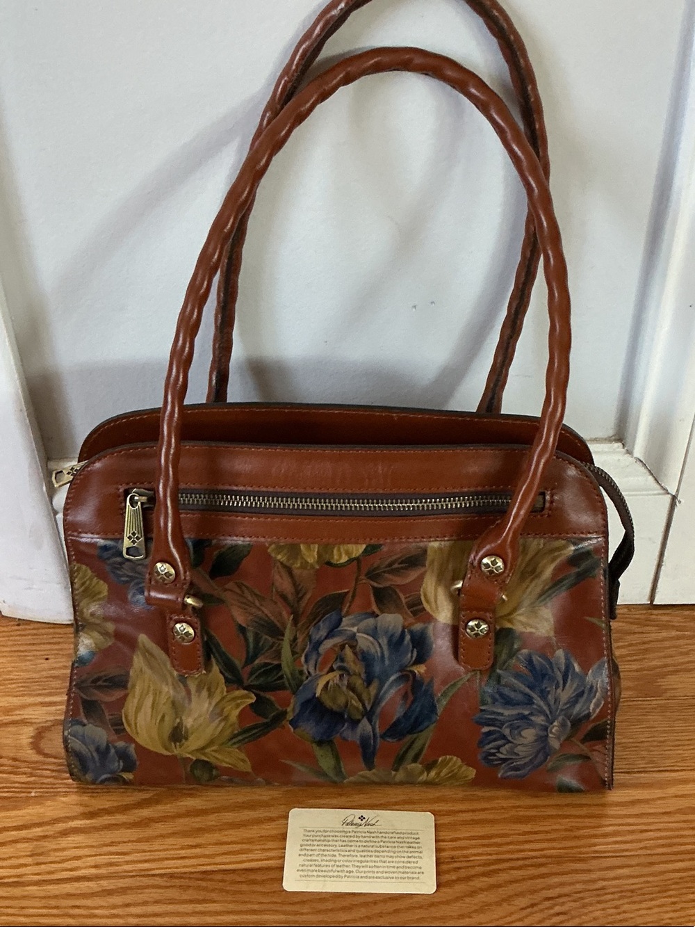 Patricia Nash Calvi handbag features a vibrant floral leather design